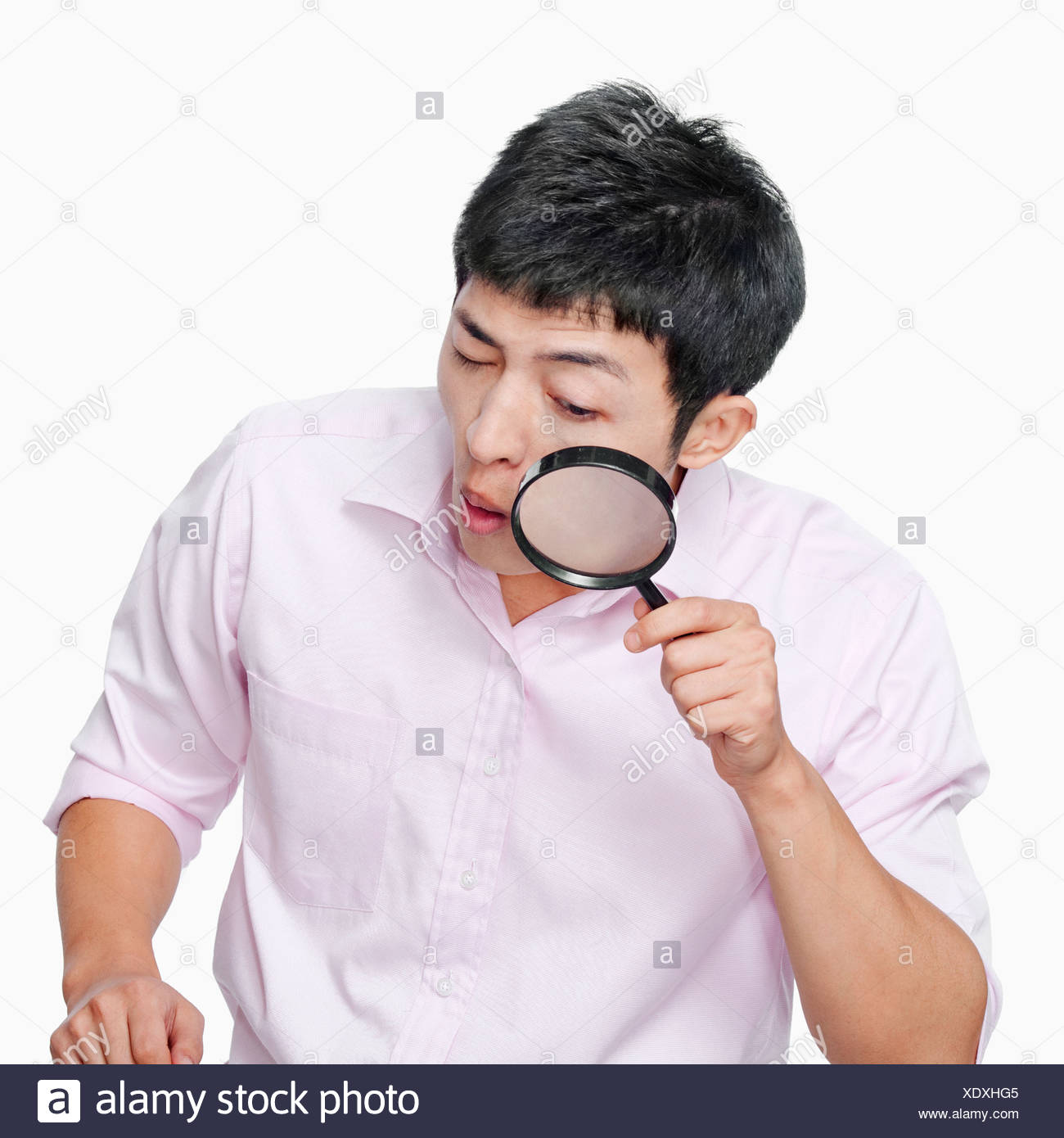 young-man-looking-through-magnifying-glass-XDXHG5.jpg