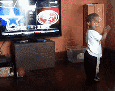 Dancing-Child-in-Front-of-TV-Screen.gif